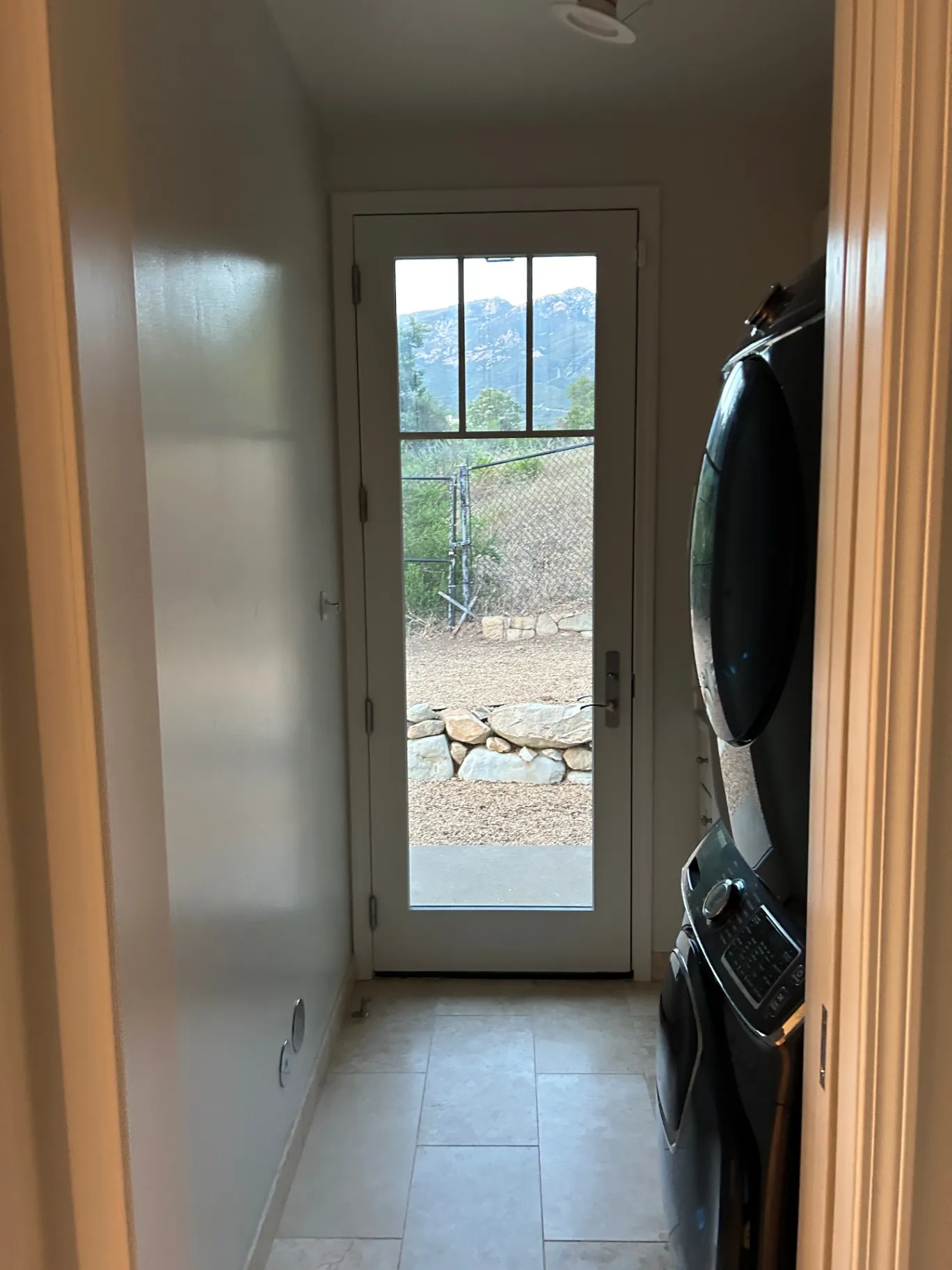 Laundry room with mountain view through glass door