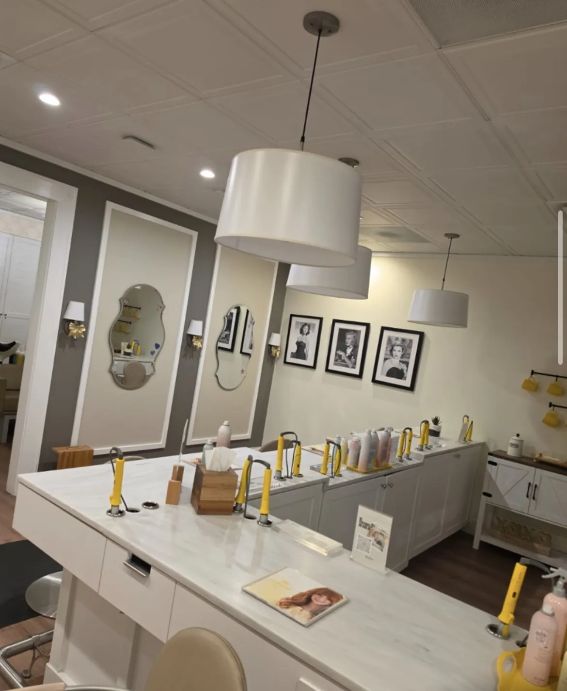 Drybar wash bar with gray accent wall and gallery frames