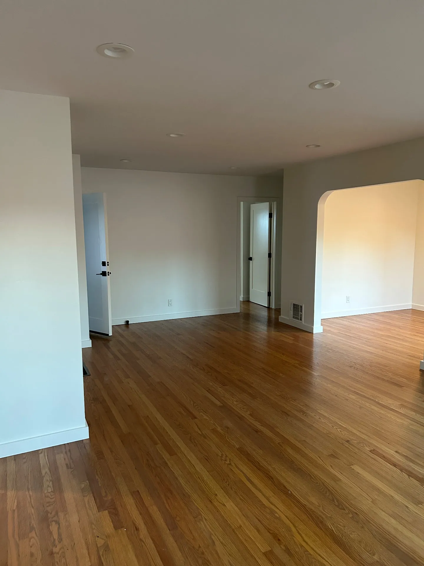 Repainted living room with archway, doors and trim in San Roque home