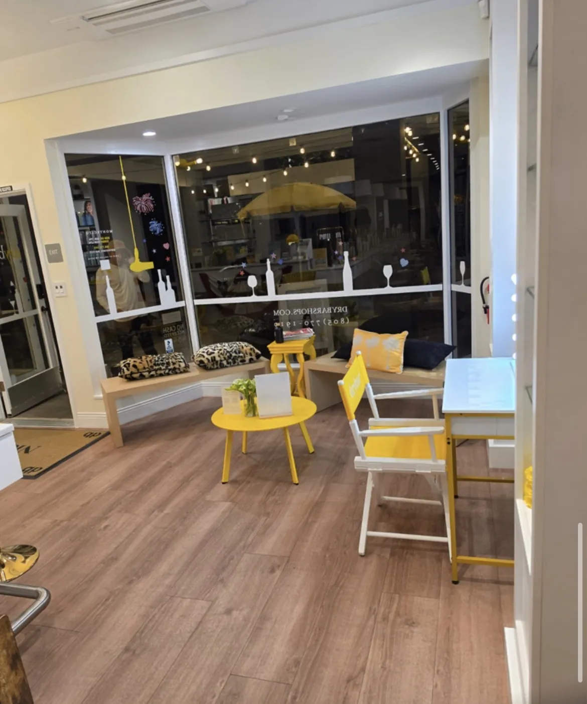 Drybar storefront waiting area with yellow furniture