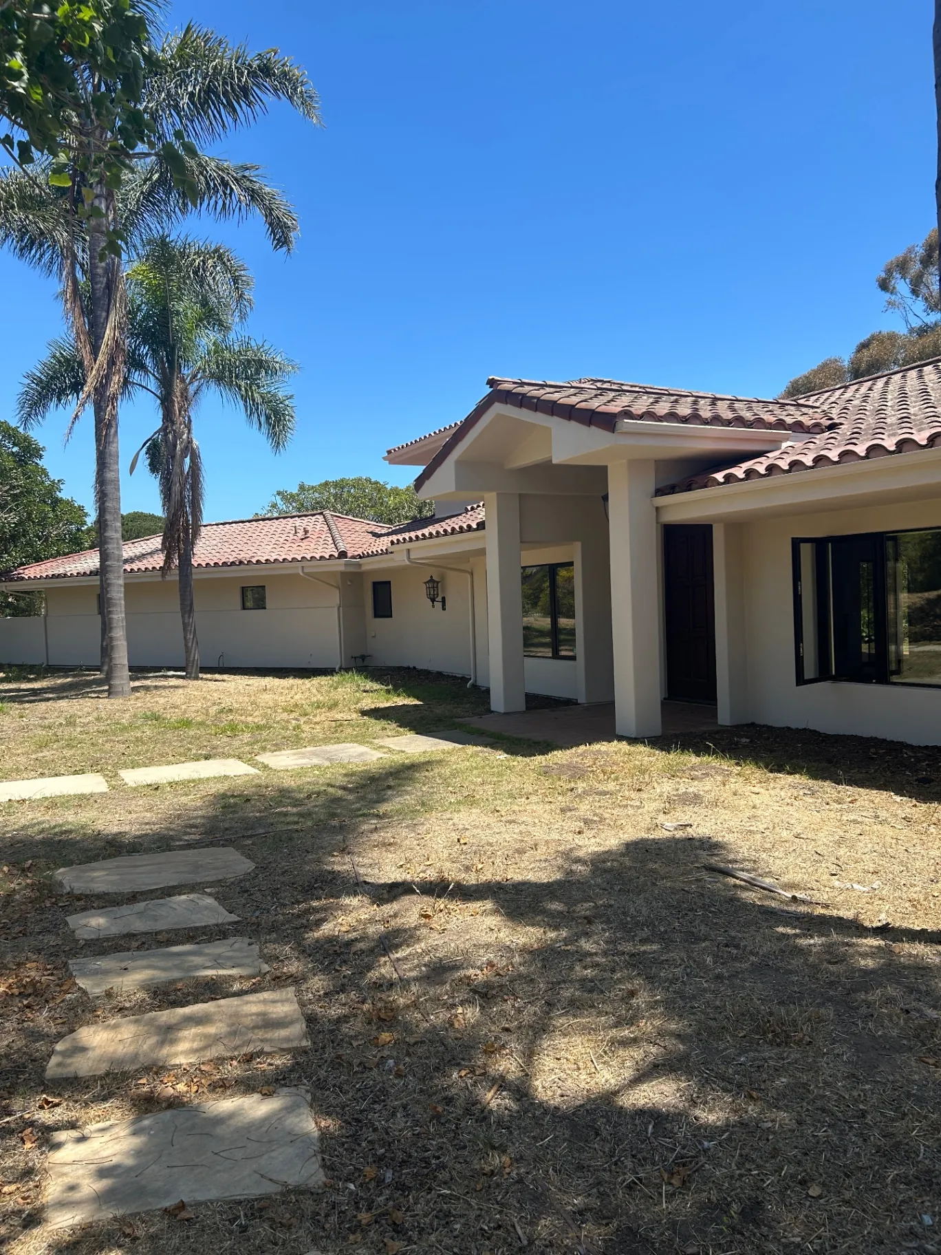 Front entry of Spanish-style estate after exterior repaint