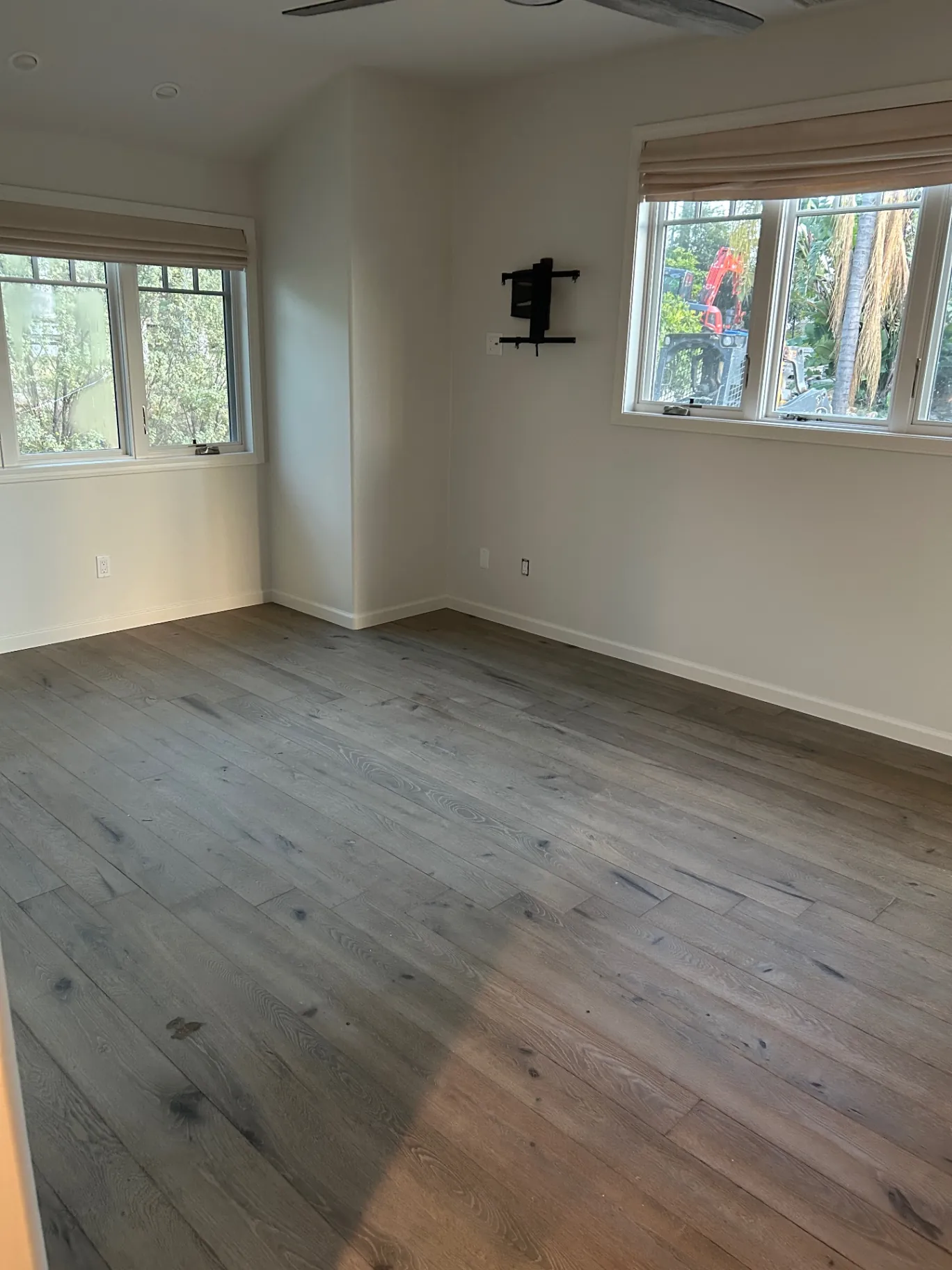 Empty bedroom with neutral walls and large windows
