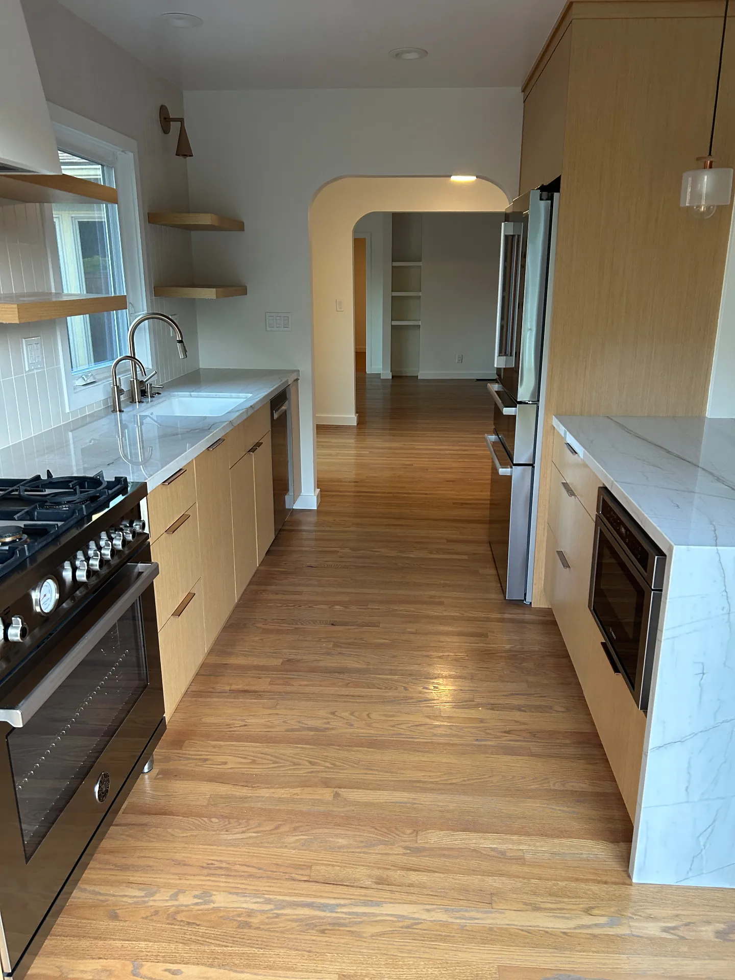 Freshly painted San Roque kitchen with warm oak cabinets and white walls